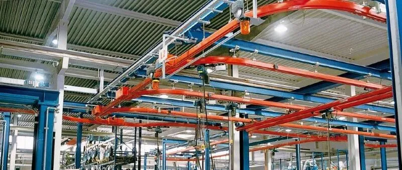 Industrial monorail crane system transporting heavy parts along fixed track